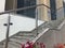 Stainless steel chrome plated finished hand rails with glass panels for an ramp or staircase steps for an building interiors for