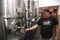 Stainless steel fermentation kettle. Brewmaster closing the tank.