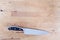 Stainless Steel Kitchen Knife over Cutting Board