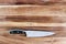 Stainless Steel Kitchen Knife over Wood Table
