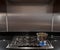 Stainless steel pan on gas hob in a modern kitchen