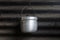 Stainless steel pot hang in old kitchen with zinc background