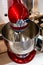 Stainless steel red electric mixer. Hand or stand mixer. Kitchen device. Selective focus close-up