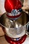 Stainless steel red electric mixer. Hand or stand mixer. Kitchen device. Selective focus close-up