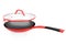 Stainless steel red frying pan with glass lid and chrome cookware on white