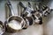 Stainless steel saucepans hang on wall