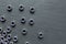 Stainless steel screw nuts on a black texture background