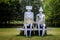 Stainless steel Sitting Couple on Bench Sculpture by Lynn Chadwick  in grounds of  Salisbury Cathedral, Salisbury, Wiltshire, UK