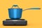 Stainless steel stewpot on portable camping electric stove on yellow background