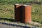 Stainless steel with a surface rusty oxidized layer of rust. in the square in the park are these metal trash cans. two next to eac