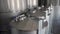 Stainless steel tanks of distilling unit at winery or brewery