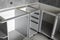 Stainless telescopic bayonet drawer slide guides, installed on a kitchen cabinet from gray chipboard. Accessories for