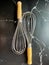 Stainless whisk with handle wood is equipment in bakery work.
