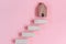 Stair Ladder to Success of Business Strategic, Goal Target Development to Success. Wooden Stair With House Model on Pink