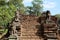 The stair of the ruined medieval university in Cambodia. Stone figures of animals. Ancient ruins