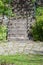 Stair structure of concrete with slate stones and iron railing. Stone walkway with grass and moss patterns