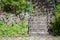 Stair structure of concrete with slate stones and iron railing. Stone walkway with grass and moss patterns