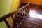 A staircas with wooden railings, steps and landings