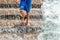 A staircase for bathers in the Atlantic Ocean, a young man jumping down the stairs