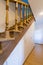 Staircase with carved wooden railings in a building between floors