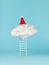 A staircase ending in a cloud and a red hood on a blue background