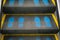 Staircase escalator in shopping mall moving up with blue footprint graphic symbol