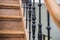 Staircase Handrailing in Old Historic Building. Interior Decor of Vintage Stairs with Metal Ornament and White Wall Background.