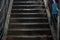 Staircase in a pedestrian crossing. Dirty stairs in artificial light. Steps up.