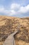 The staircase rises to a sandy dune. Climbing to the top in the desert