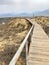 The staircase rises to a sandy dune. Climbing to the top in the desert