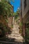 Staircase rising in narrow alley in ChÃ¢teaudouble.