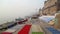 Stairs of Ganges river covered with sheets, with people passing.