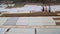 Stairs of Ganges river covered with sheets, with people passing.