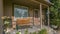 Stairs leading to porch with bench and brown door