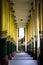 Stairs leading up to shwedagon pagoda Yangon Myanmar with man at the end of pillers from both sides.