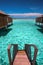 Stairs from overwater bungalow to the lagoon on tropical island