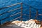 Stairs, rusted railing and Mediterranean sea