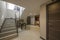 Stairs of a single-family home with metal railing and stoneware floors