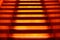 Stairway with orange and yellow lights along steps creating a vector illustration