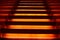 Stairway with orange and yellow lights along steps creating a vector illustration