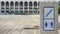 Stairway with restroom signs on marble podium in front of outdoor courtyard in public area