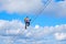 Stairway to heaven concept. Woman climbing a diagonal via ferrata ladder in Donnerkogel mountains, Austria, near Gosau.