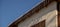 stalactite ice hangs from the roof of the house winter background