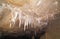 Stalactites on cave ceiling