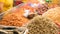 A stall vendor selling dry shrimp fish and various ingredients in popular market