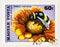 Stamp with a Bumblebee Pollinating a Flower