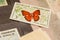 Stamp with butterfly among other stamps
