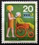 A stamp printed in Germany shows woman Assisting