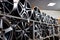 stand with alloy wheels in modern tire store, close up