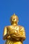 Stand Golden Buddha Statue on sky in Thailand